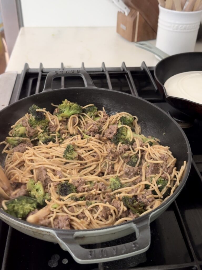 Step-by-step photo of cooking broccoli in a skillet with sesame oil