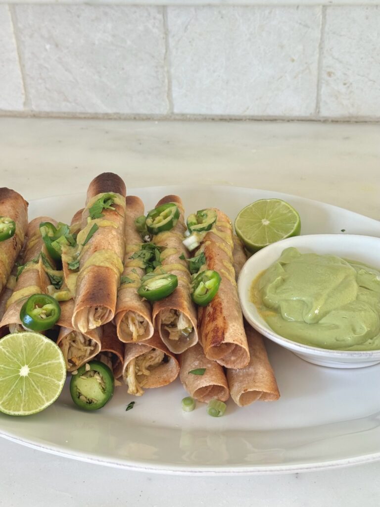 Tray of golden, crispy chicken taquitos fresh from the oven