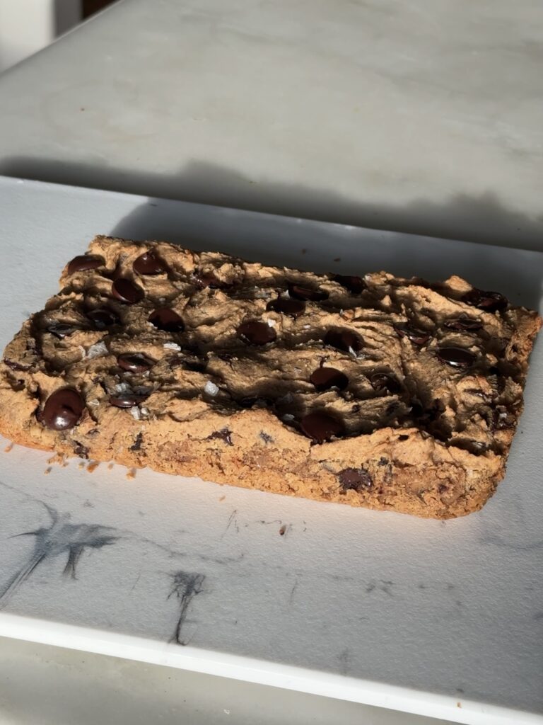 fudgy chickpea blondies served on a white plate.