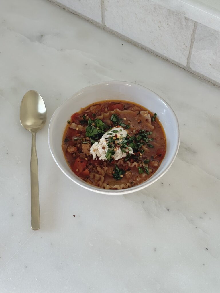 One-pot lasagna soup served in a bowl with a spoon ready to eat
