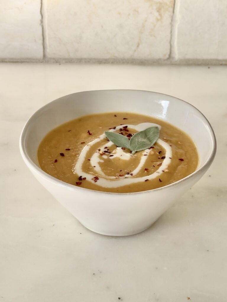 Finished Sage Butternut Squash Soup served hot, garnished with toasted sage and red pepper flakes