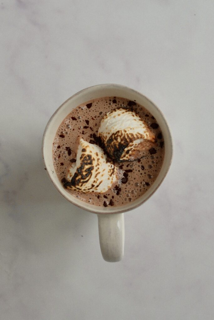 Protein hot chocolate made with almond milk and cacao powder, topped with marshmallows.