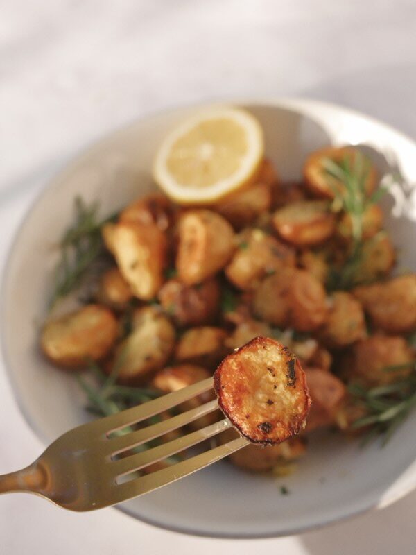 finished potatoes topped with lemon zest, parsley, and flaky sea salt