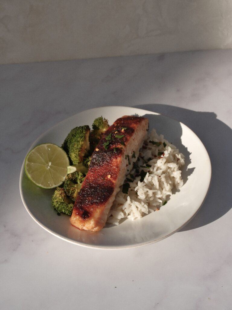 finished salmon on sheet pan with lime and herbs